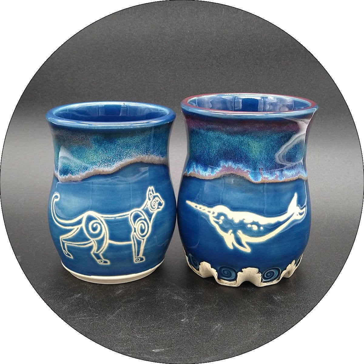 Three cups with original raven artwork